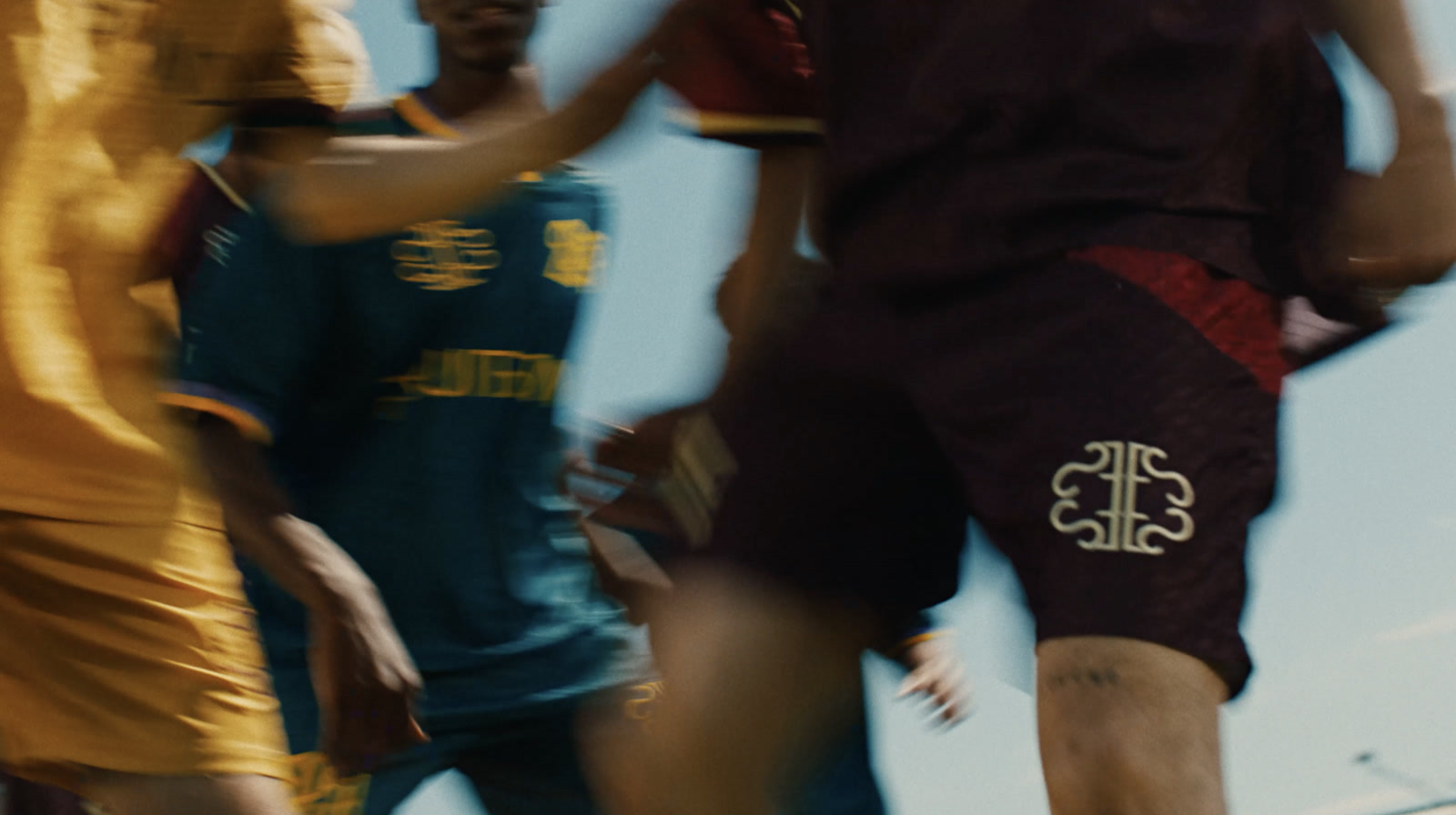 Players in the SS26 kits mid-game, motion blurred