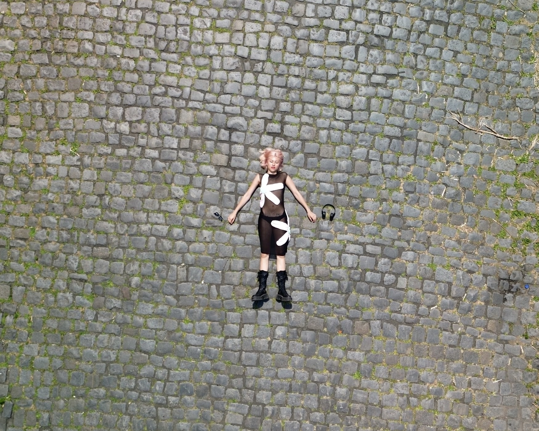 Annabelle lying on cobblestones, shot from above